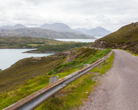4407561 highlands of scotland narrow road in mountain landscape