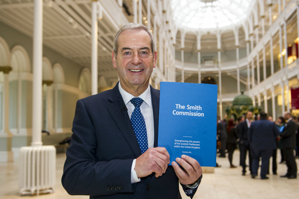 Lord Smith of Kelvin holding the Commission's report