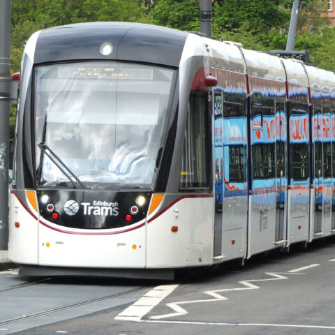 Caption: An Edinburgh tram on Princes Street. The city is considering the next major expansion of the network, with proposed routes towards Granton in the north and the Royal