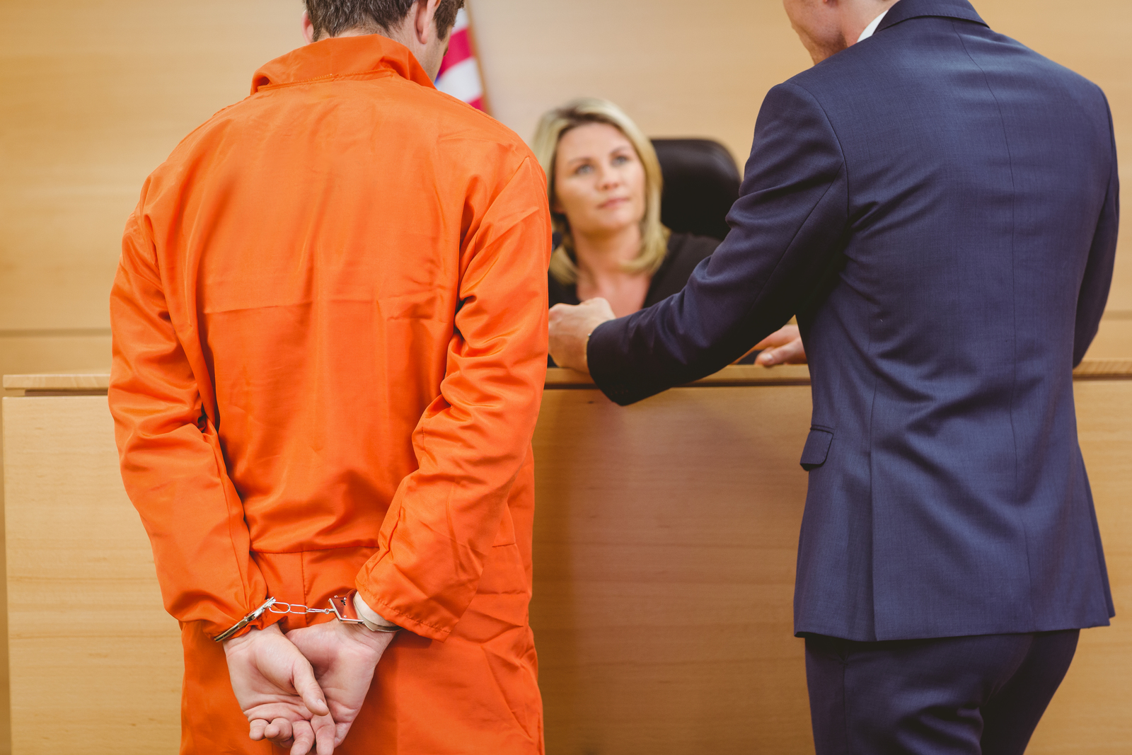 16682622 lawyer and judge speaking next to the criminal in handcuffs